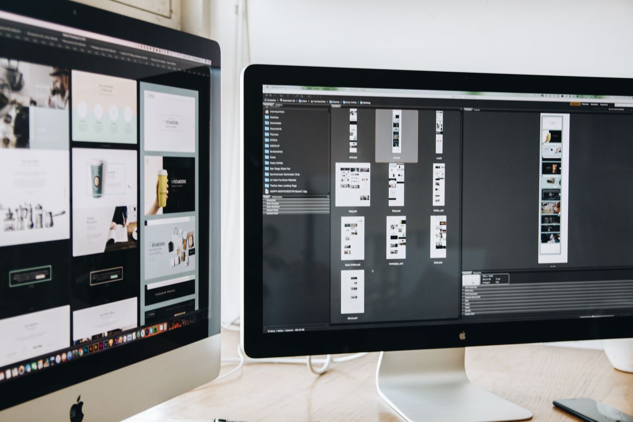 A contemporary workspace with two computer monitors showing web design projects, highlighting technology and productivity.